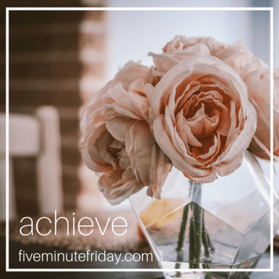 a glass vase with light pink flowers. 