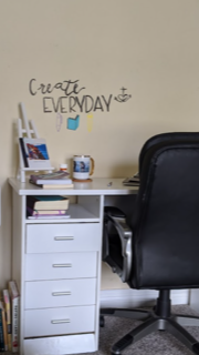 photo of desk, chair, coffee, and many books